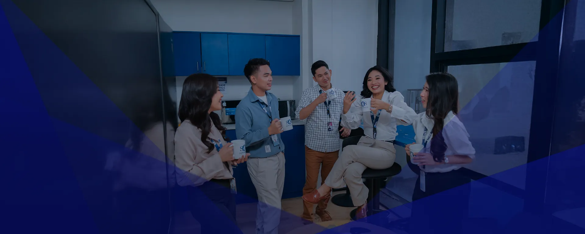Office colleagues chatting and having coffee together.
