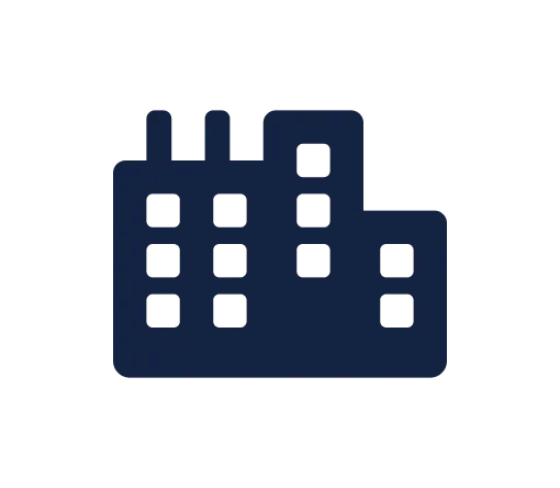 Silhouette of a factory building with smokestacks.
