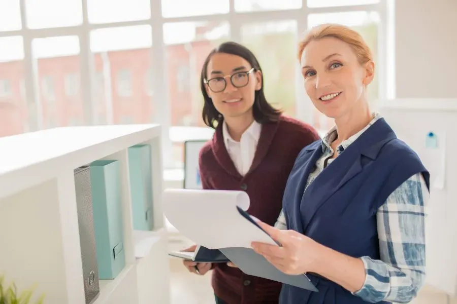 Two accountants working through figures together at a desk