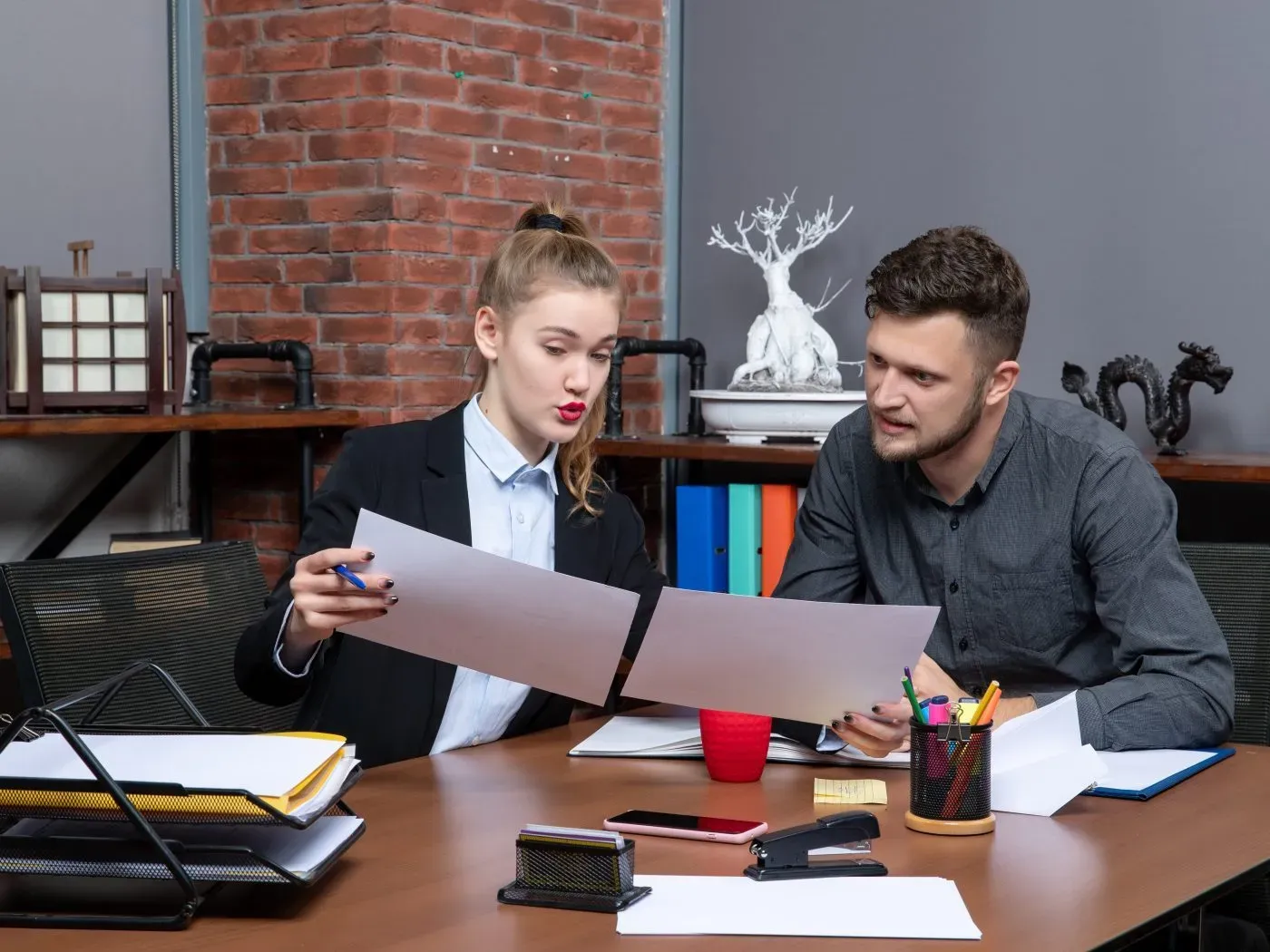 Clerical team working through documents in an office