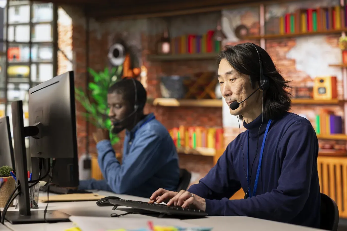 Call centre team at their desks wearing headsets, helping customers